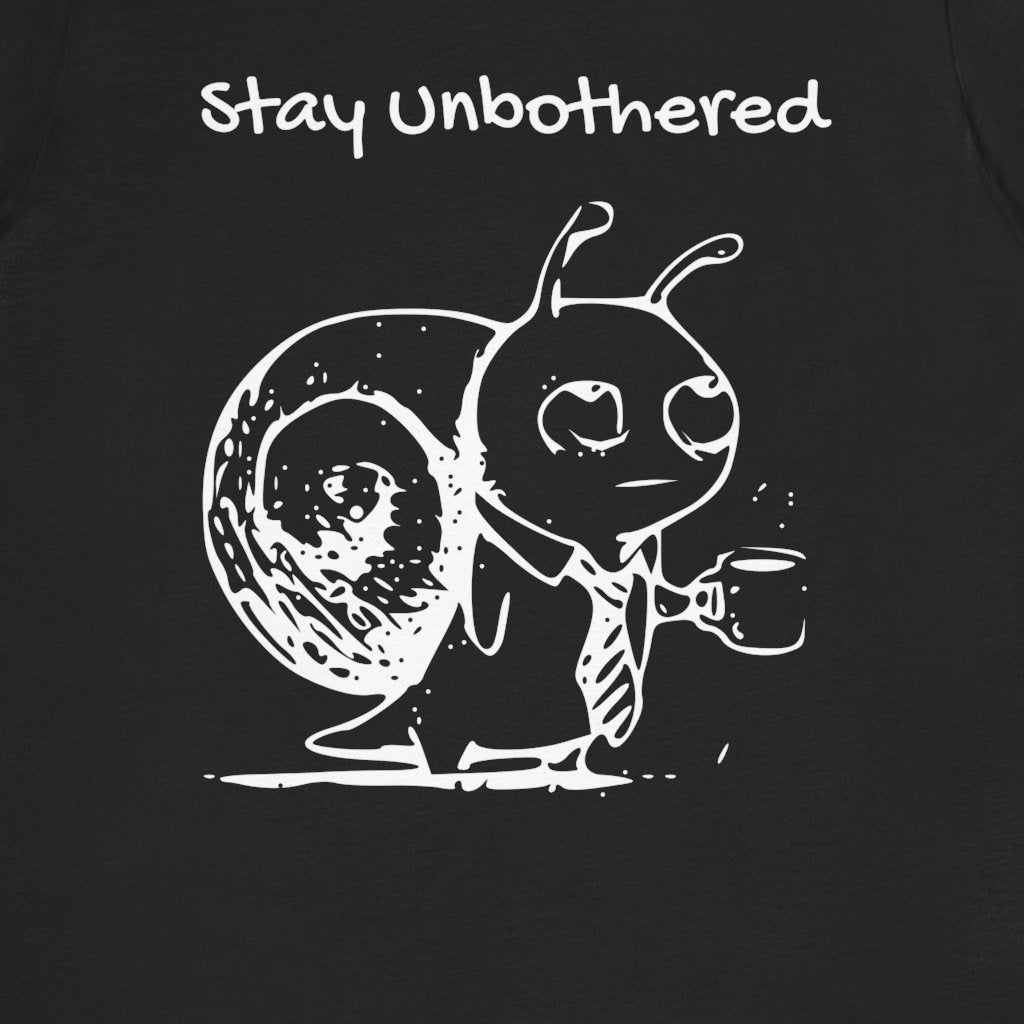 Close view of the Stay Unbothered slogan and Snail holding a coffee mug on the black T-shirt.