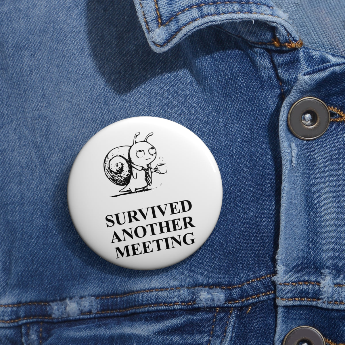 Corporate Snail award badge, one 2.25-inch badge shown on denim